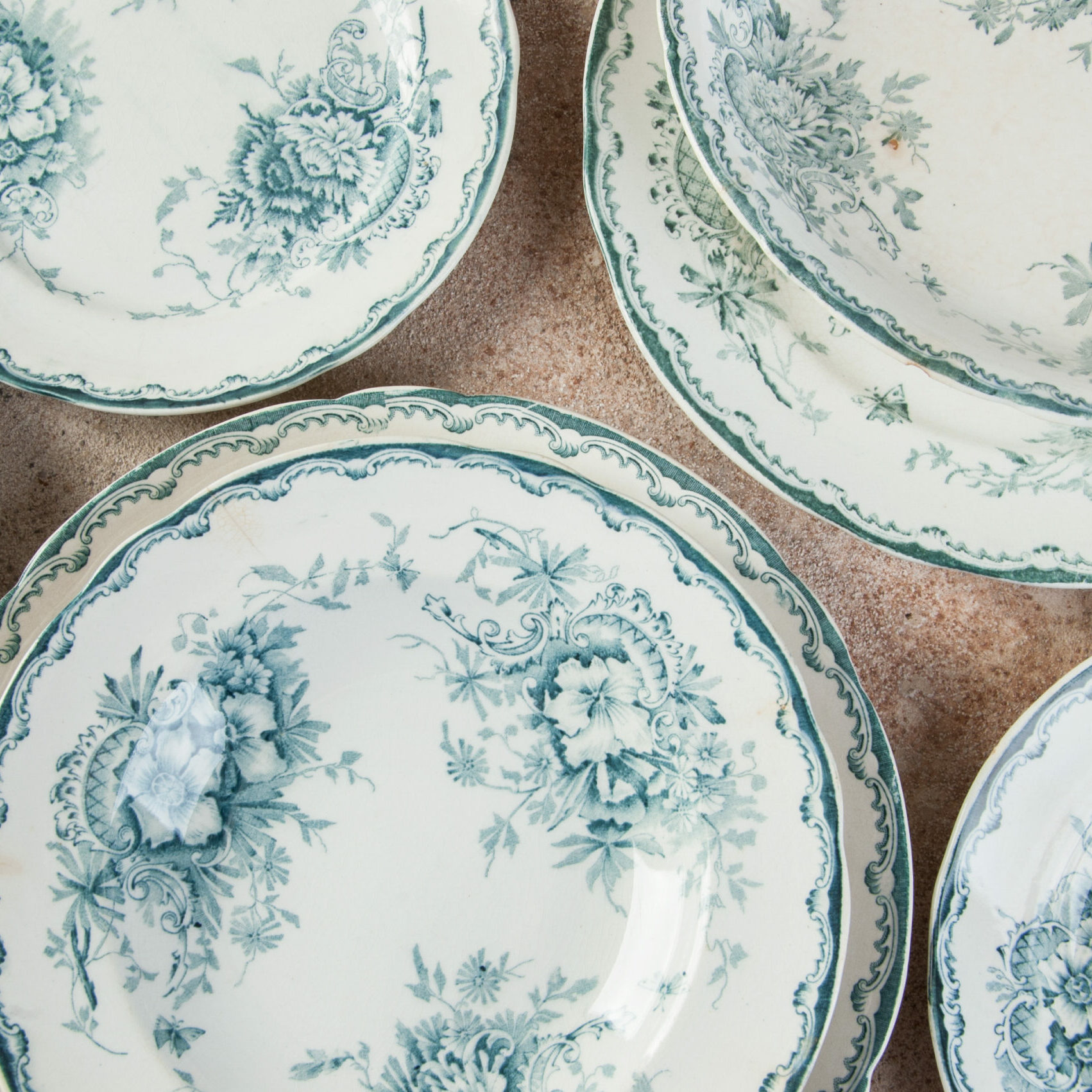 Antique porcelain dishes on concrete